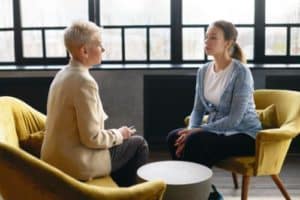 a woman talking to her friend about starting anxiety treatment