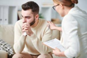 a man being comforted by his doctor about starting cocaine rehab