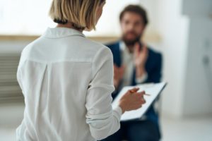 a person talks to a counselor during psychiatric treatment