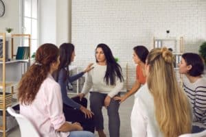 people talk in a group during an addiction aftercare program