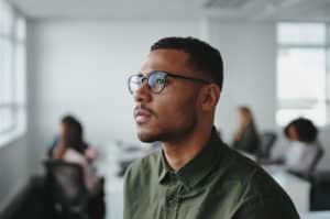 man in glasses looking out the window preparing for iop