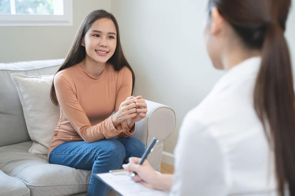Woman on couch working through her iop expectations