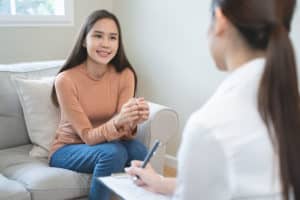 Woman on couch working through her iop expectations