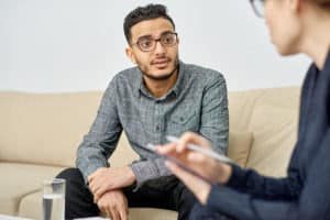 man in glasses on couch learns about php expectations