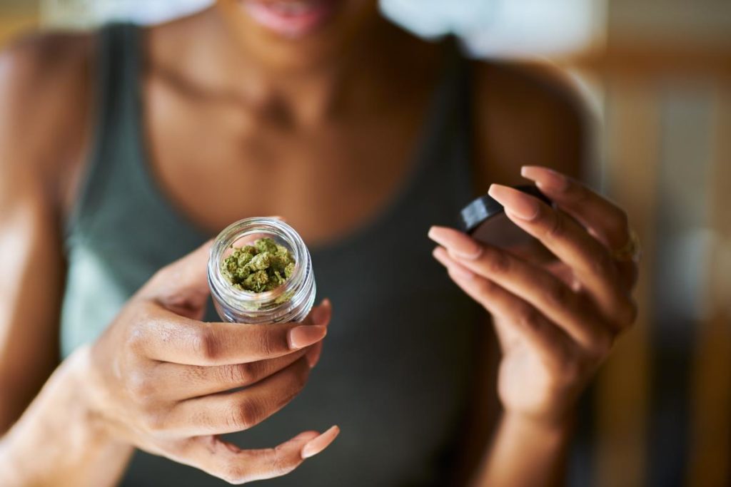 woman holding marijuana and wondering is marijuana addictive