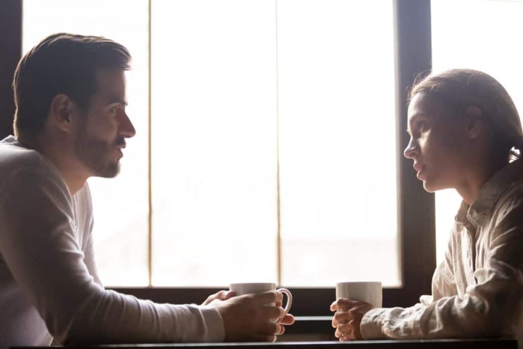 man and woman sitting by window considering rebuilding relationships