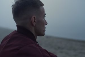 a person looks over a field in dramatic lighting and deals with heroin withdrawal symptoms