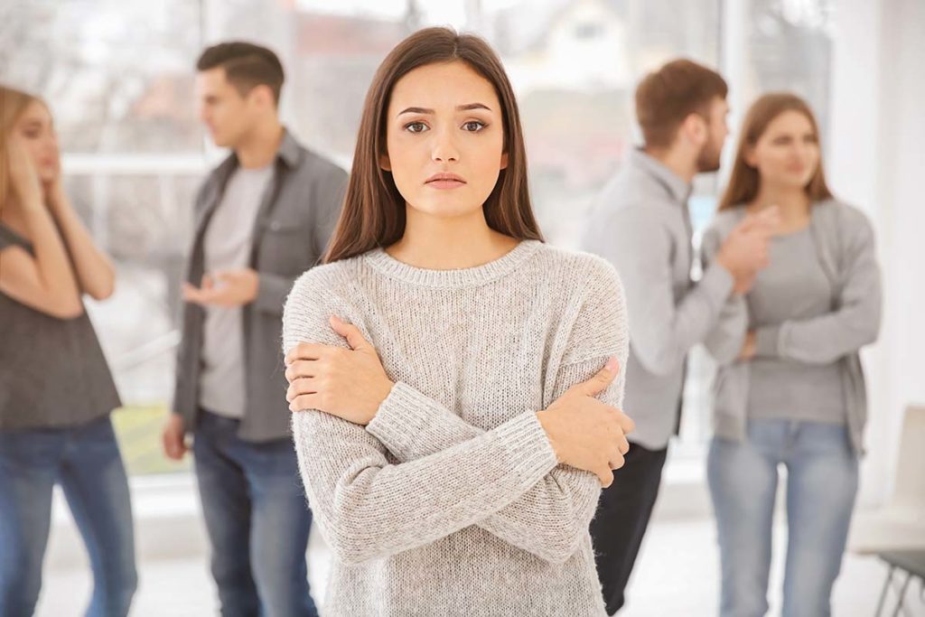 a person looking nervous in a group of people experiences social anxiety