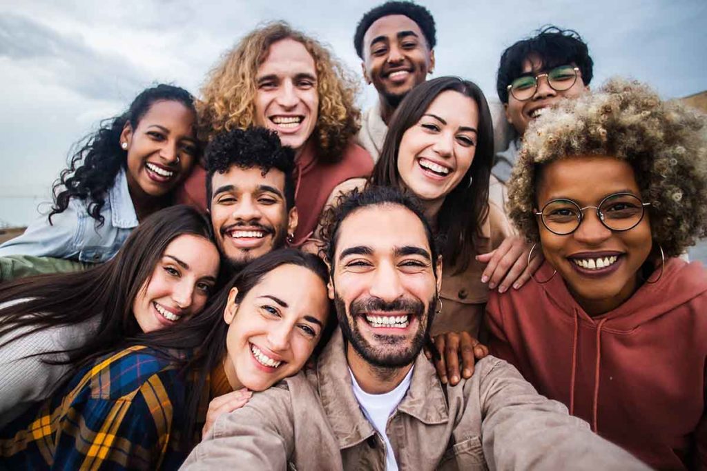 a person takes a selfie of a group of people after learning about what is an aftercare program