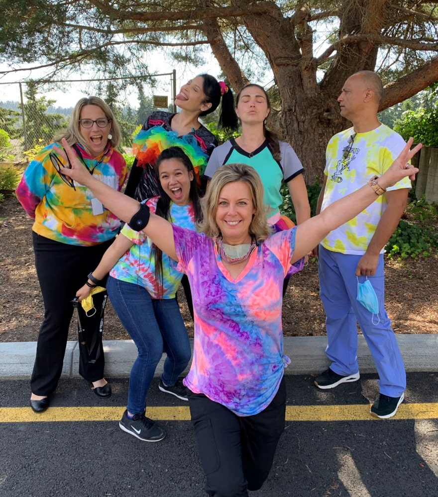 group-posing-with-colorful-shirts-on-roadside.jpg