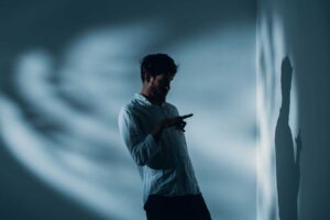 a person appears to be talking to themself in a dark room as they show warning signs of cocaine abuse