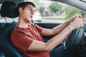 a person looks inebriated in a car to display marijuana use and driving