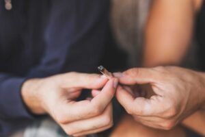 two people share a joint while experiencing long-term marijuana use