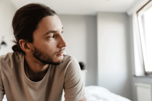 a person looks outside their bedroom to break the cycle of depression