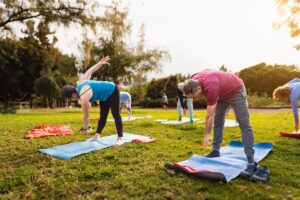 a yoga class practices yoga outdoors as a way to participate in outdoor activities to fight depression