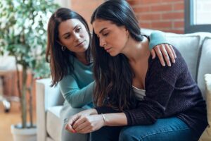 a person comforts another after recognizing signs of heroin use