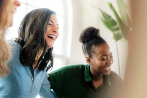 Woman laughs as she discovers happiness and other benefits of cognitive behavioral therapy