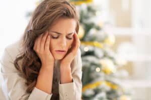 Woman rests head in hands and ponders how how meth affects the brain