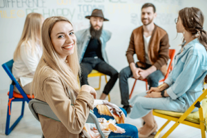 Woman smiles while talking to peers in an aftercare program