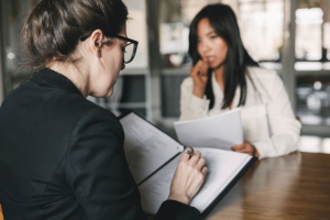 Man talking to therapist writes down tips for social anxiety