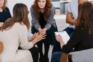 A group of people experiencing the benefits of group counseling